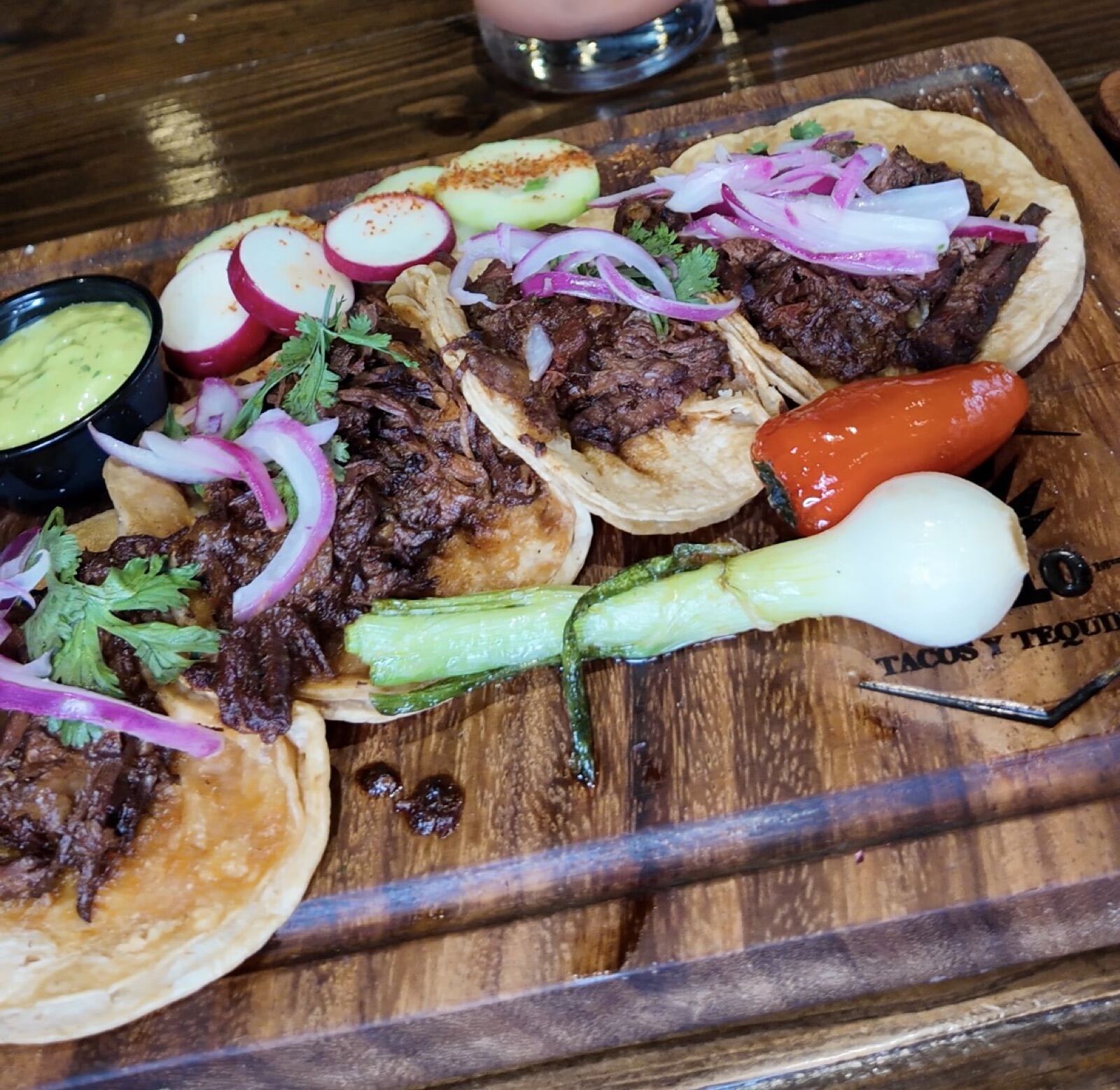 Barbacoa tacos on a wooden board at 1810 Tacos y Tequila in Jacksonville Beach
